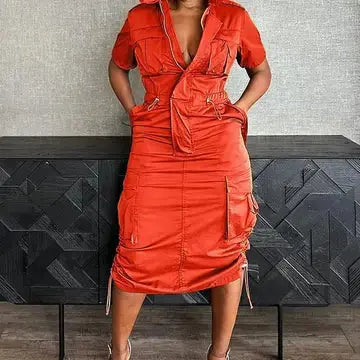 Orange utility pocket shirt dress with adjustable waist – front view.