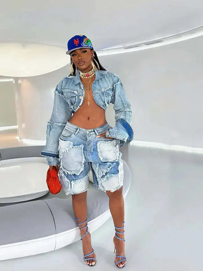 Model in distressed denim patchwork set with cropped jacket and skirt standing confidently.