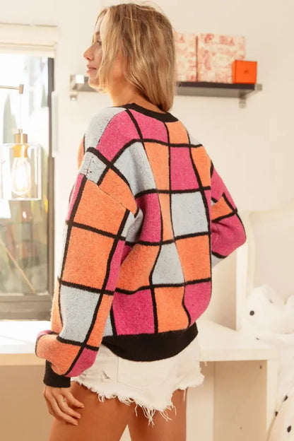 Model wearing BiBi checker sweater—playful pose - slanted back view.