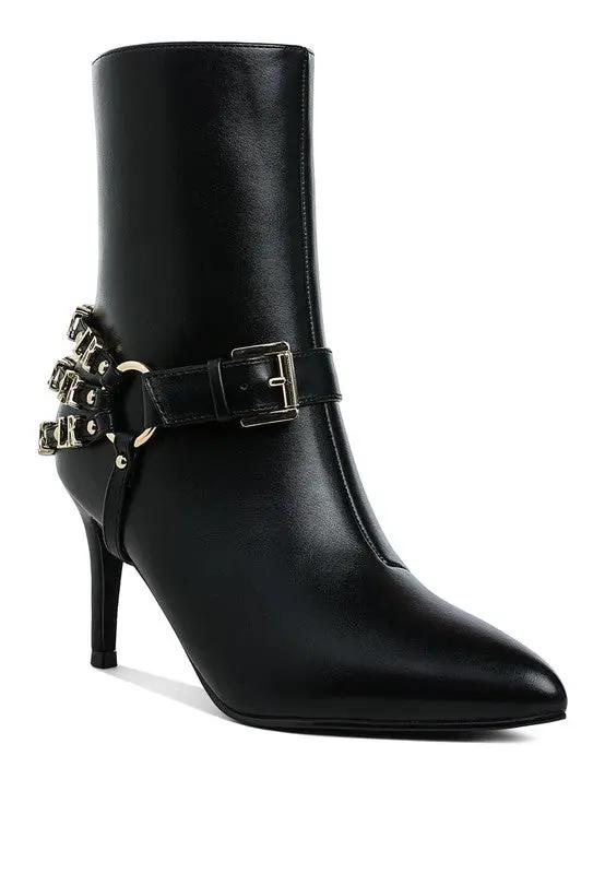 Side view of harness detail stiletto boots in black with pointed toe.