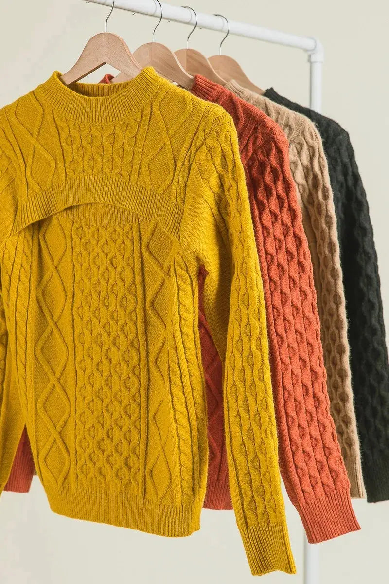 Side view of mustard yellow cable-knit cut-out sweater on hanger