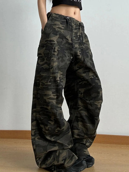 Side view of camo cargo pants for women featuring wide leg cut and utility pockets.
