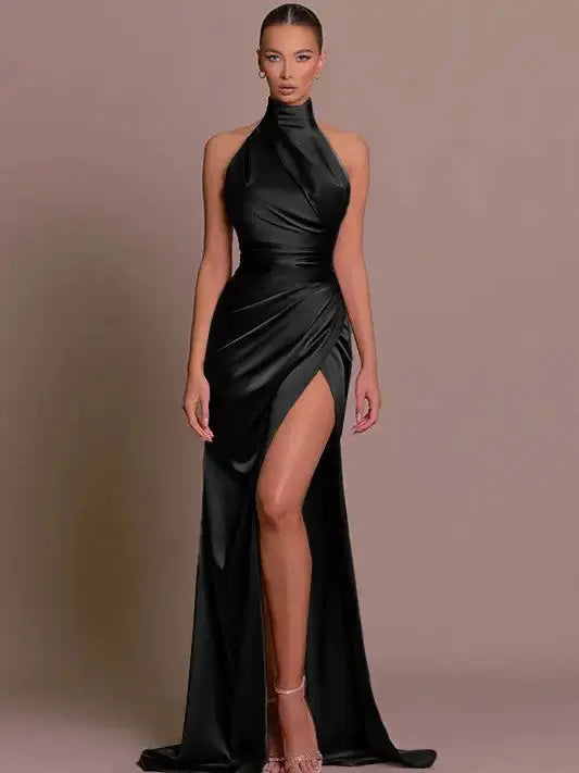 Black stand collar halter slit dress with high leg slit on model.