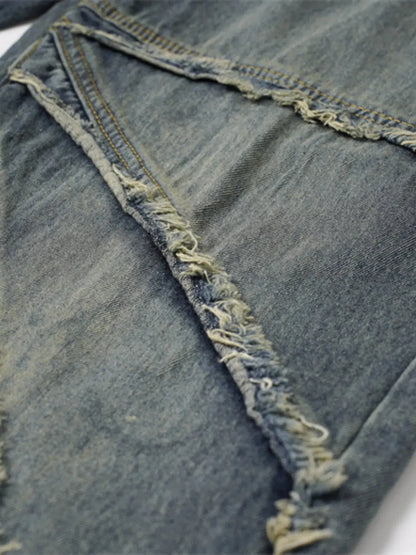 Close-up of frayed seam detailing on washed denim.
