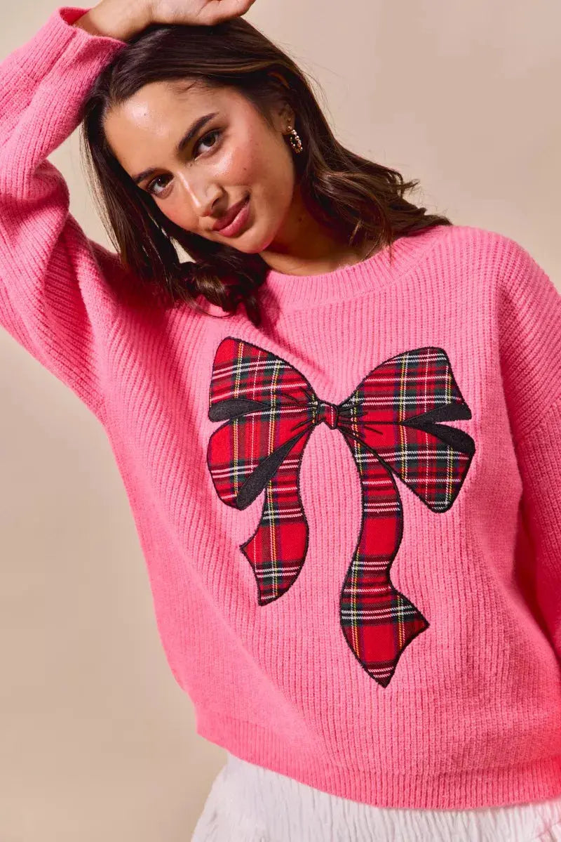 Model showcasing relaxed fit holiday knit sweater.