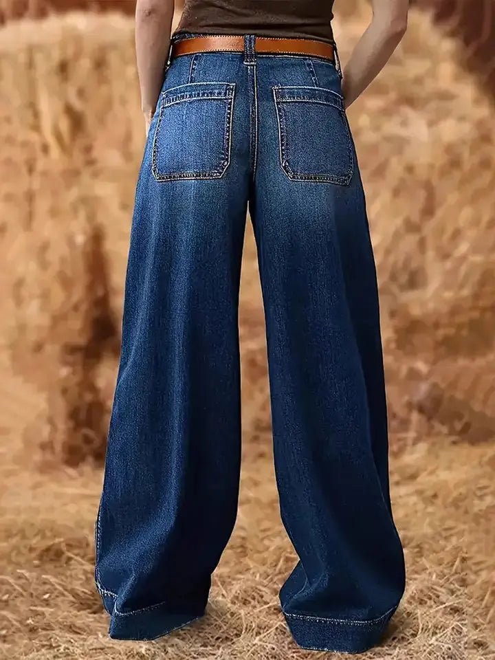 Close-up of high waist and pockets on denim jeans.