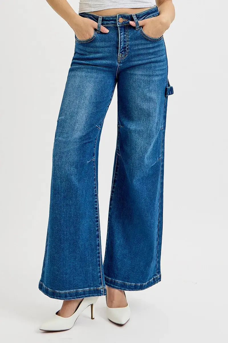 Wide-leg silhouette of high-rise patch detailed denim jeans on model with hands on pocket