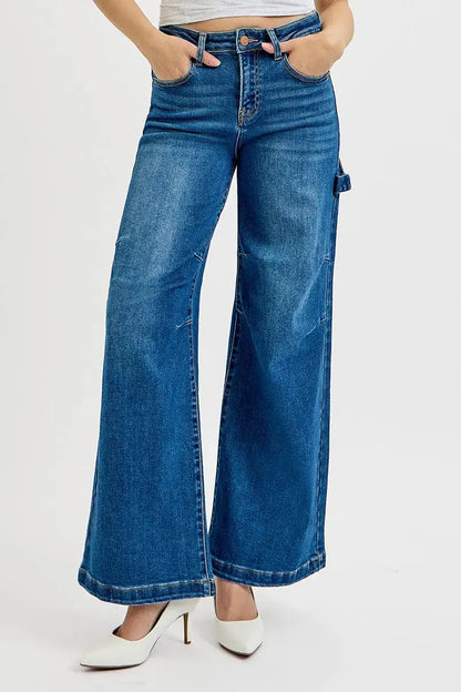 Wide-leg silhouette of high-rise patch detailed denim jeans on model with hands on pocket