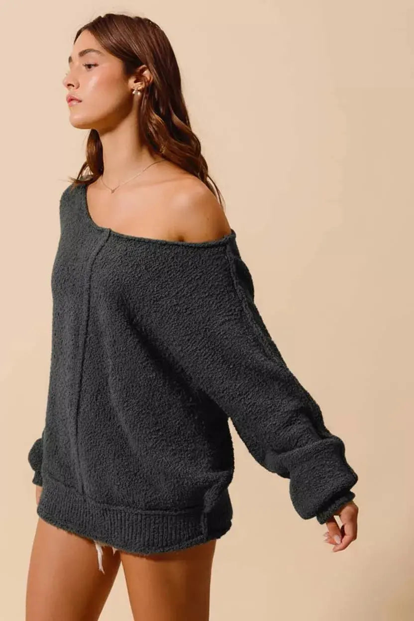 Loose fit exposed seam slouchy boucle sweater — side angle view