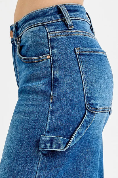 Patch detail close-up on high-rise wide-leg denim jeans.