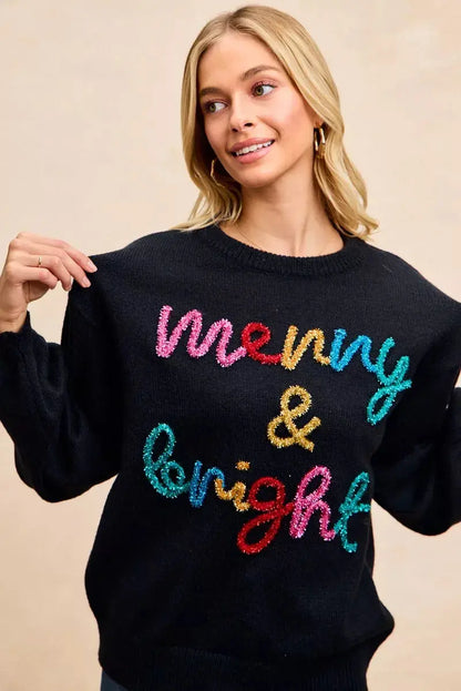 Front view of BiBi tinsel lettering holiday sweater on model.